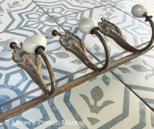 Antique French Cast Iron Wall Coat Rack | Belle Époque Porcelain Tipped Hooks | Acanthus Shell Motif